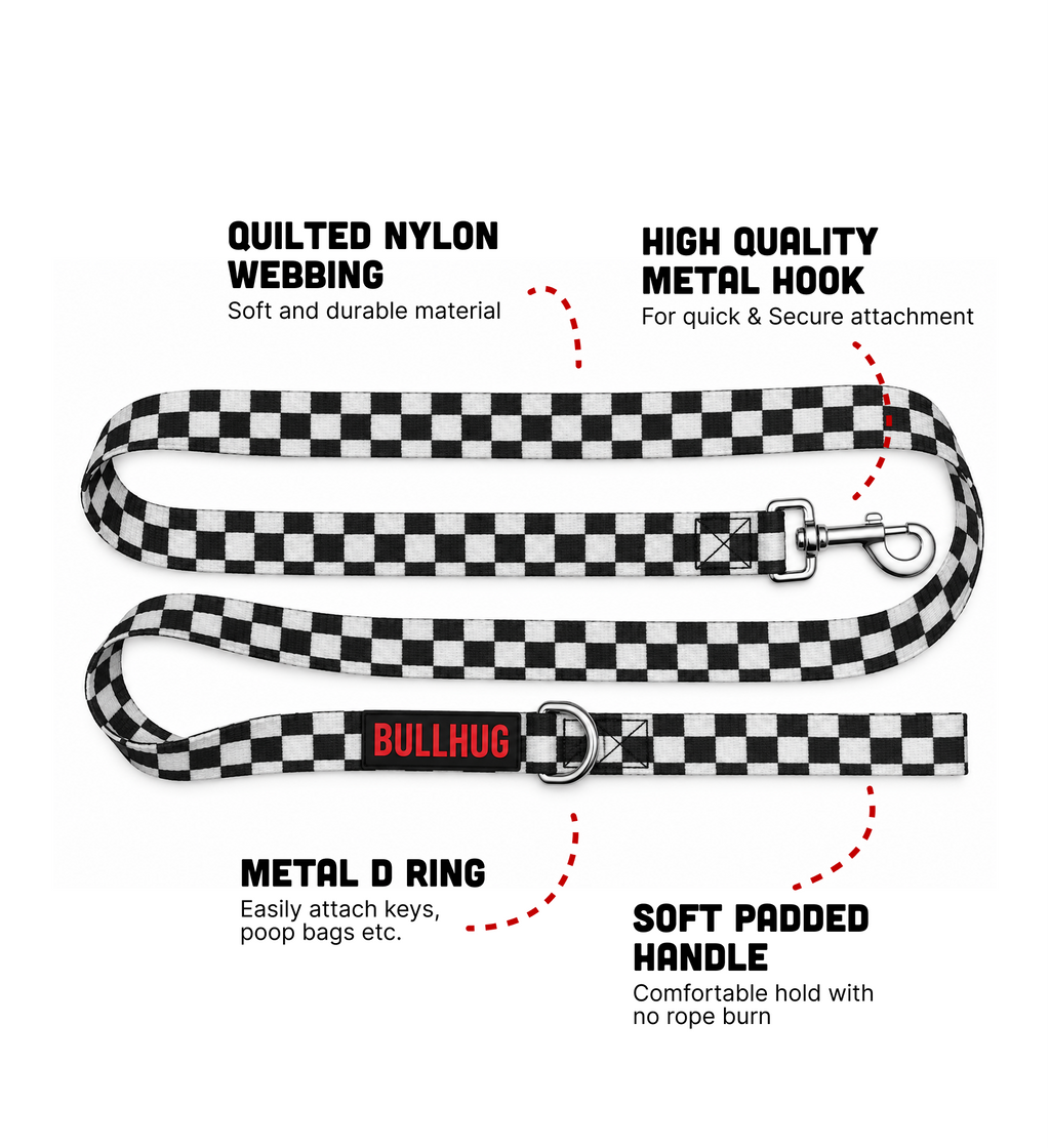 A black and white checkered nylon dog leash with a red Bullhug logo, shown with text callouts highlighting its quilted nylon webbing, high quality metal hook, metal D ring, and soft padded handle.
