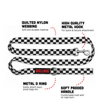 A black and white checkered nylon dog leash with a red Bullhug logo, shown with text callouts highlighting its quilted nylon webbing, high quality metal hook, metal D ring, and soft padded handle.